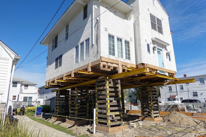 A team of professionals using specialized equipment to raise a house in Irving, preparing it for elevation and renovation